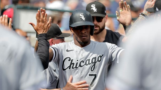 Chicago White Sox shortstop Tim Anderson receives congratulations from teammates after scoring in the seventh inning against the Detroit Tigers. (2023)